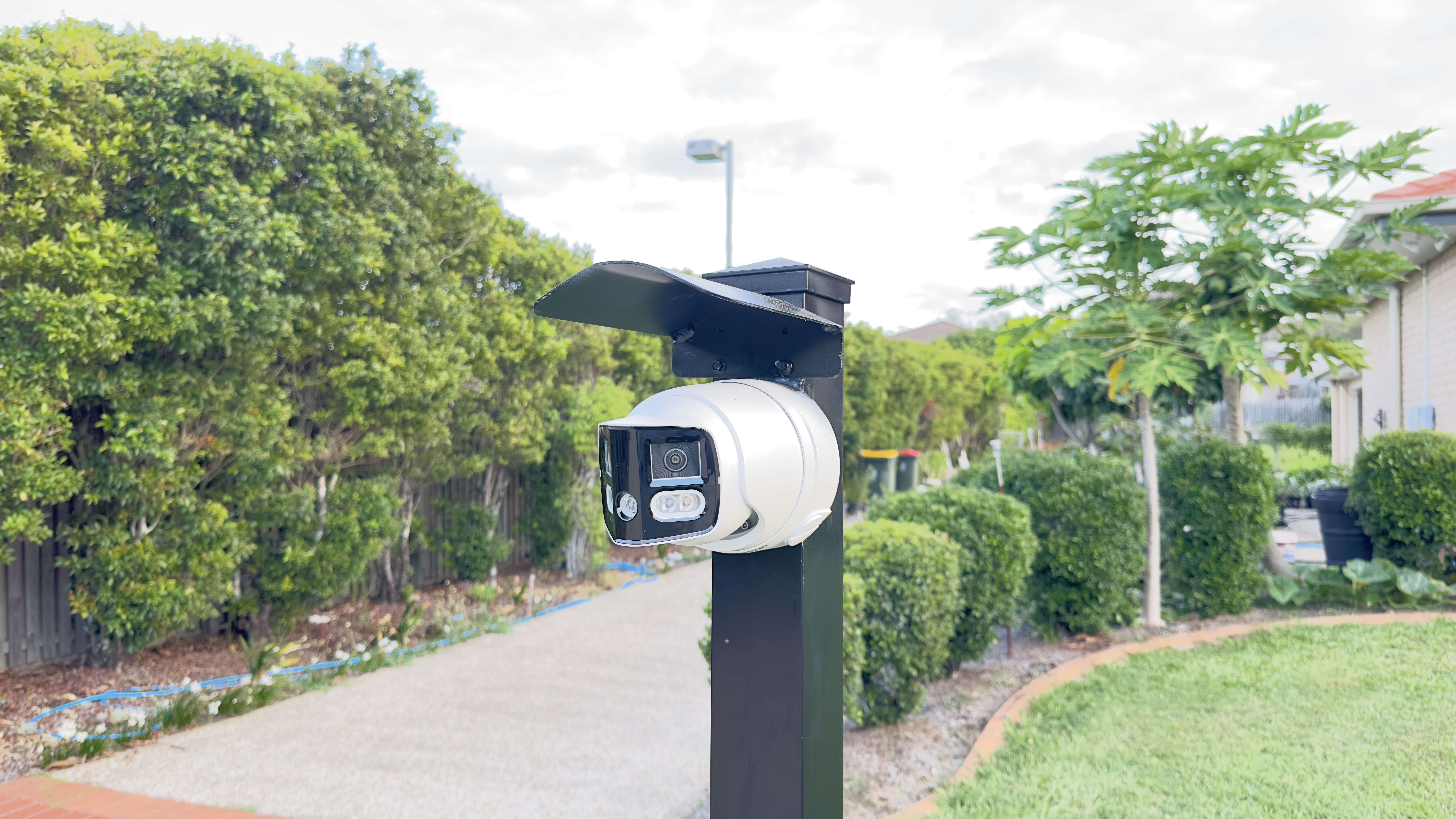 PTZ camera on post — residential driveway