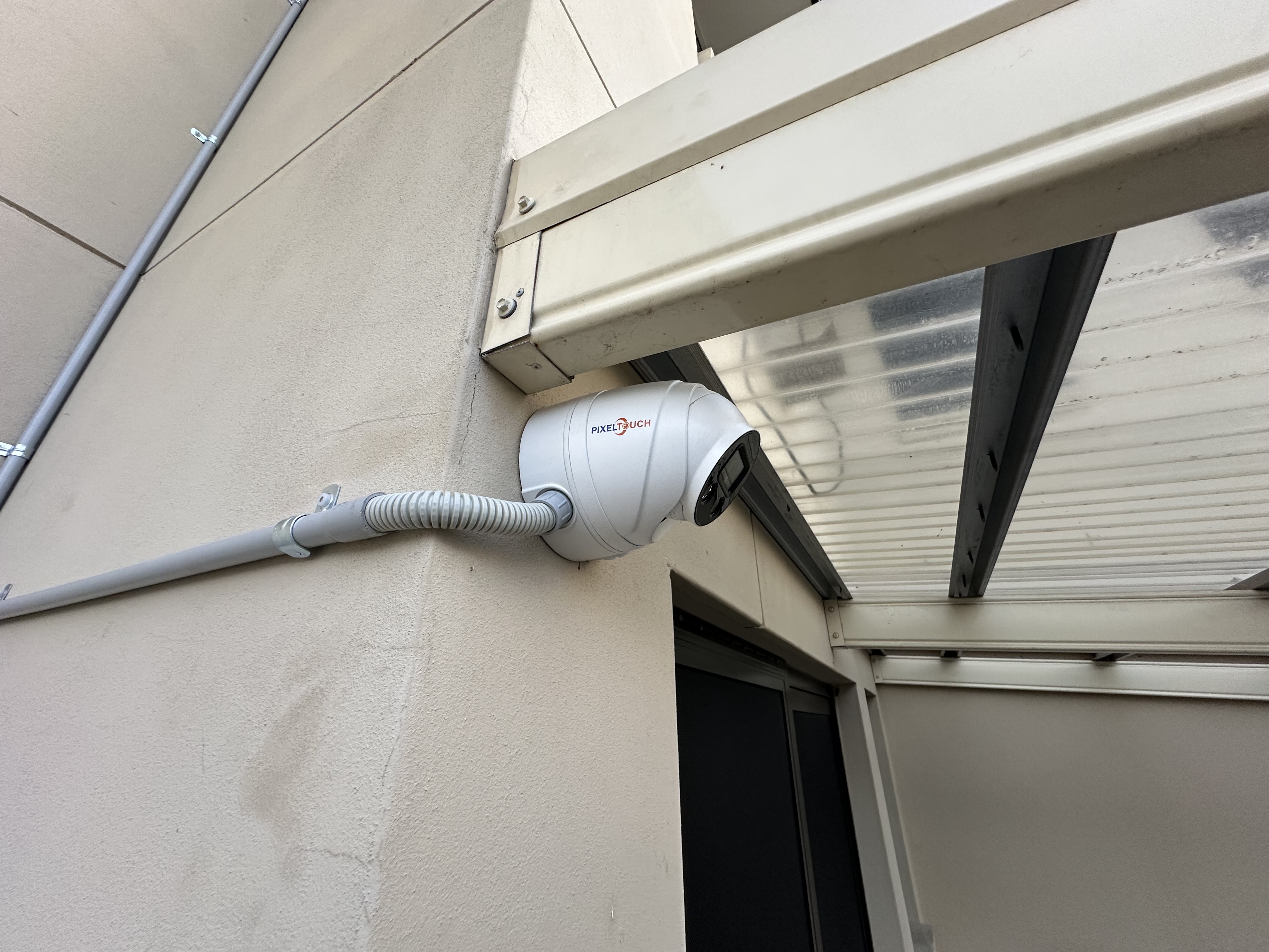 PixelTouch bullet camera on wall, covered walkway