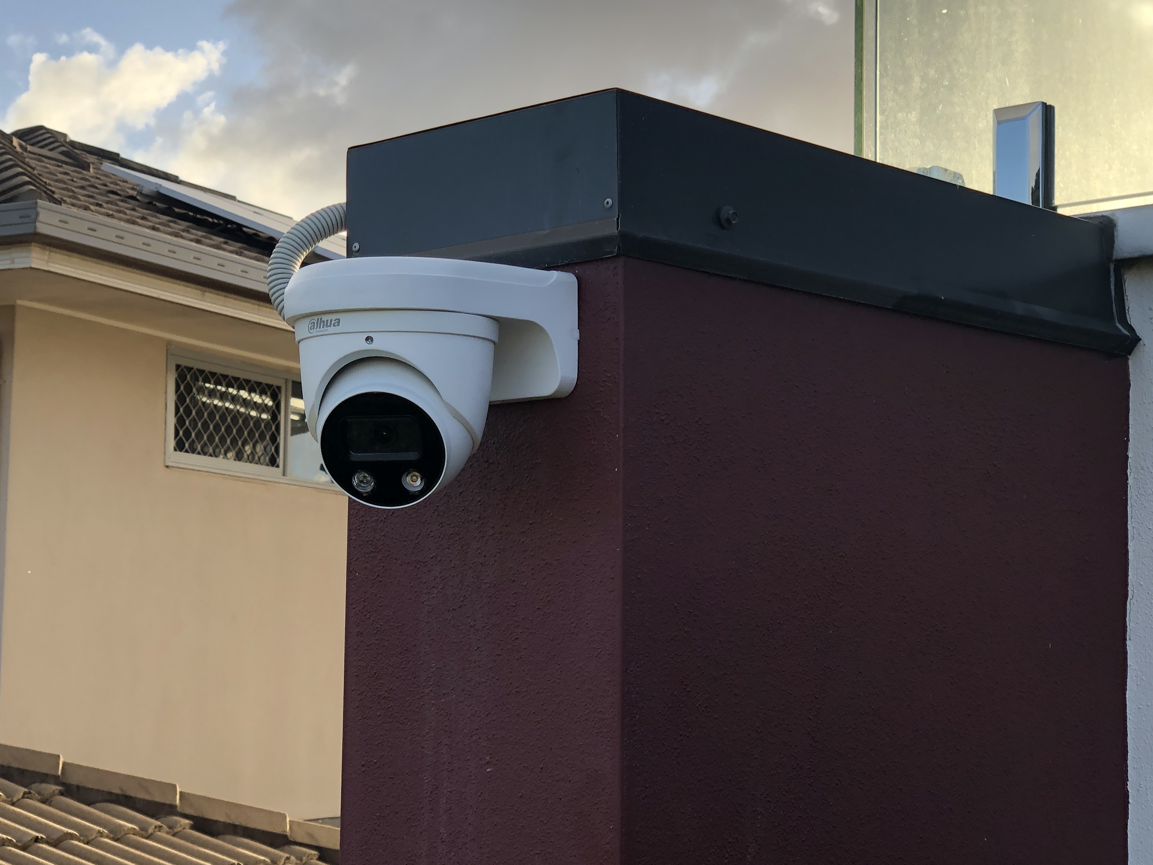 Dahua turret on dark corner pillar at dusk