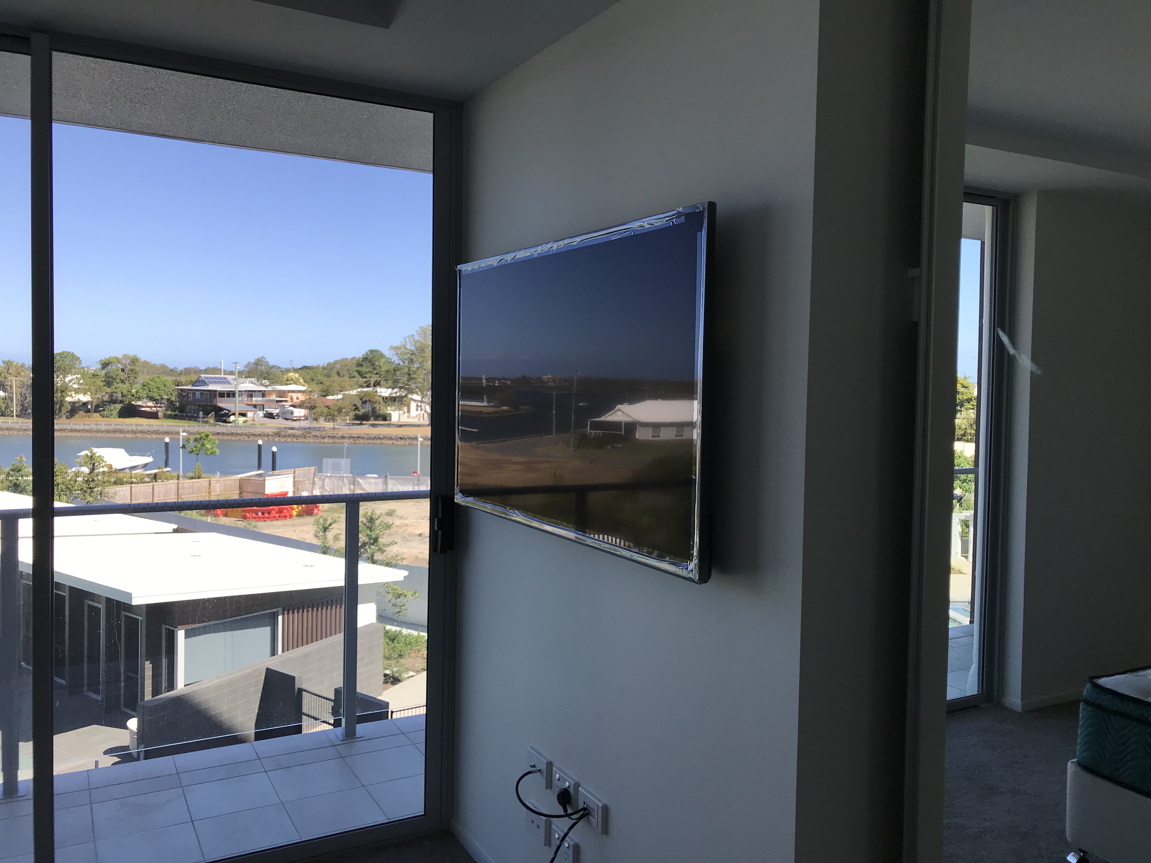 TV wall mounted in waterfront apartment