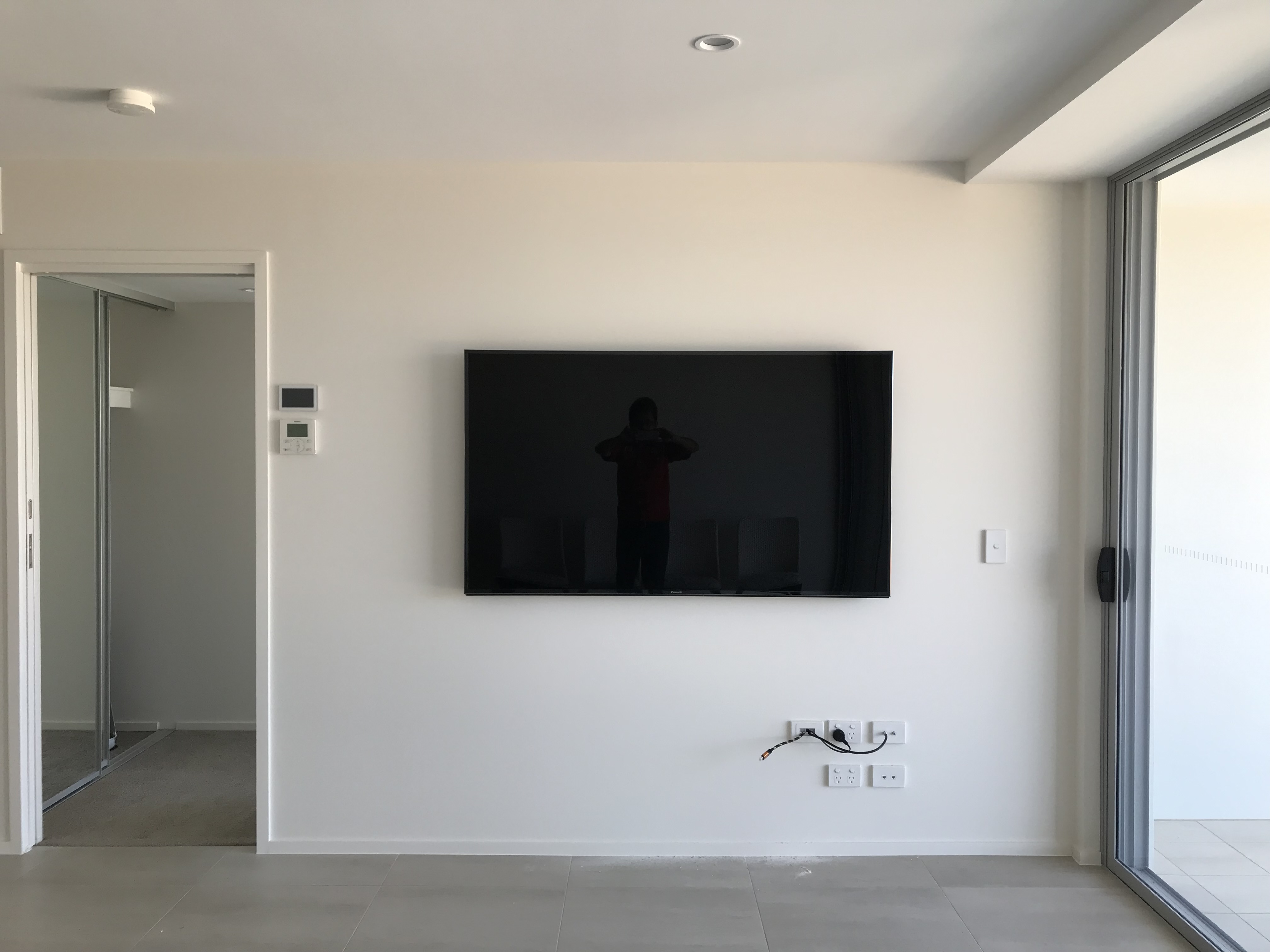 TV on white apartment wall, clean install
